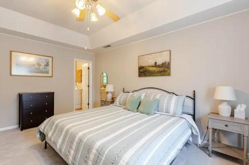 a bedroom with a bed and a ceiling fan at The Halcyon Days North Charleston in Charleston