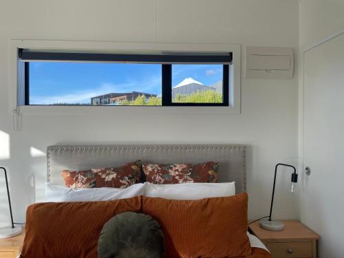 a bedroom with a bed with a window above it at Mangorei Heights - New Plymouth in New Plymouth