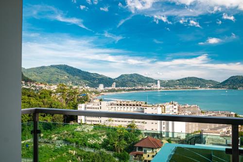 a view of the city and the water from a balcony at Patong Kalim Unparalleled Sea View B&B Resort in Patong Beach