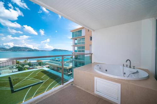 a bathroom with a tub and a view of the ocean at Patong Kalim Unparalleled Sea View B&B Resort in Patong Beach