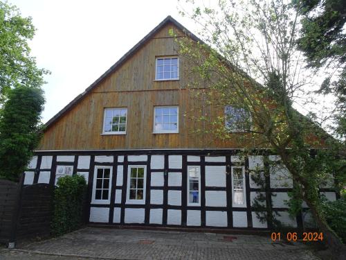 a house with a black and white building at Hotel zum alten Torfkahn in Osterholz-Scharmbeck