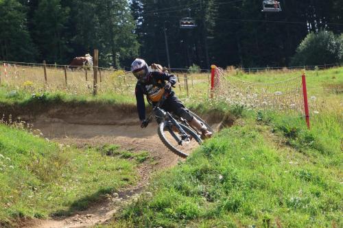 a person riding a bike on a dirt trail at Studio 4 personnes, pied des pistes ski et VTT in Métabief