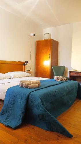 a bedroom with two beds and a blue blanket at Mirabilia 1 in Chioggia