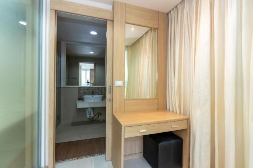 a bathroom with a sink and a mirror at Patong Kalim Unparalleled Sea View B&B Resort in Patong Beach