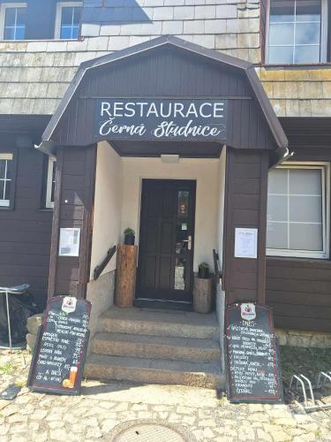 a restaurant with a sign in front of a building at Dvouložnicový apartmán Sluníčko in Zásada