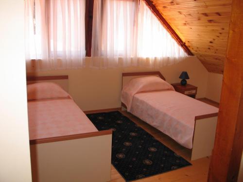 a bedroom with two beds and a window at Kovanlika Hotel in Razgrad