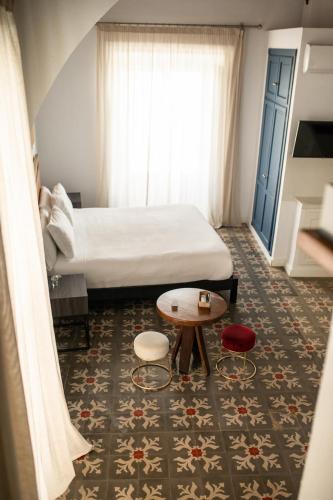 Postel nebo postele na pokoji v ubytování Apartahotel Siglo XIX