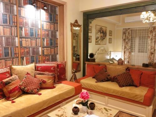a living room with a couch and a large mirror at Something About Mary in Athens