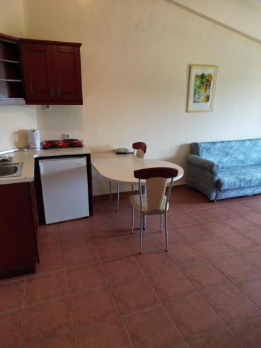a kitchen with a table and chairs and a couch at LEMAS SUITE HOTEL in Side