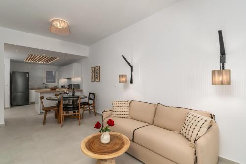 a living room with a couch and a table at Vitalis Residences - Haven Suites in Adamas