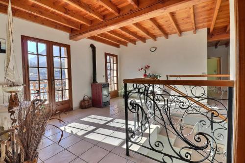 a hallway with a staircase in a house at Grande maison avec jardin in Sarrancolin