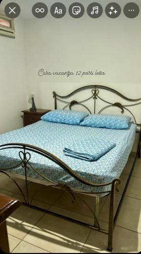 a bed in a room with a sign on the wall at DON BOSCO 2 in Bari Palese