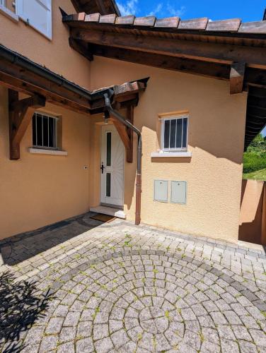 a house with a stone driveway in front of it at Sublime et calme 3,5p Terrasse et Jardin in Aubonne