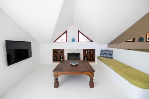 a living room with a table and a fireplace at Hotel Begonvil in Kas