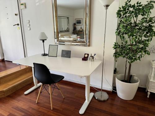 a white desk with a chair and a mirror at Vouliagmeni Seaside Escape in Athens