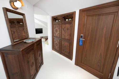a room with two wooden doors and a mirror at Hotel Begonvil in Kas