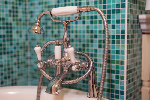 a bathroom faucet with candles on top of a sink at Boutique Hotel Dobra Vila Bovec in Bovec