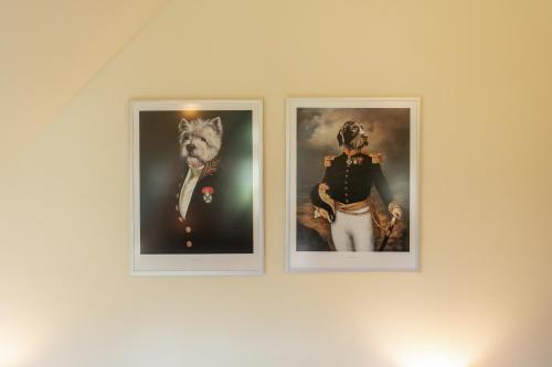 three framed pictures of a man and a tiger at Boutique Hotel Dobra Vila Bovec in Bovec