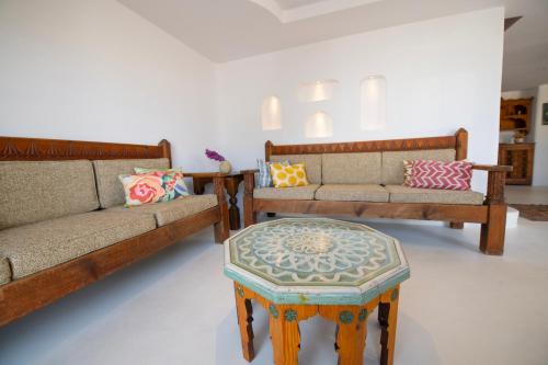 a living room with two couches and a table at Hotel Begonvil in Kas
