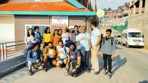 a group of people posing for a picture in front of a building at Mountain View New Kufri in Cheog