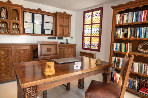 a dining room with a table and chairs and a window at Hotel Begonvil in Kas