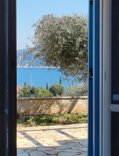 an open door looking out at a view of a yard at Villa Sasà in Fiskardo
