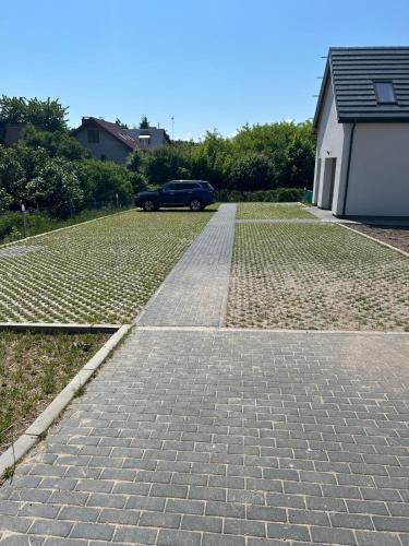 a car parked in a parking lot with a driveway at OSADA WISEŁKA in Wisełka