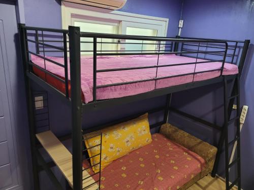 two bunk beds with a couch in a room at Jeju Vision House in Jeju