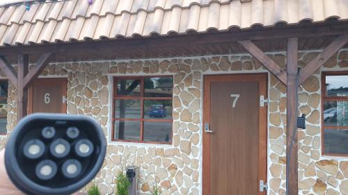 a remote control in front of a stone house at Tawerna Rataje Pokoje Gościnne in Chodzież