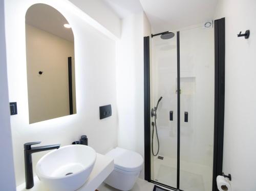 a bathroom with a shower and a toilet and a sink at Hotel Begonvil in Kas