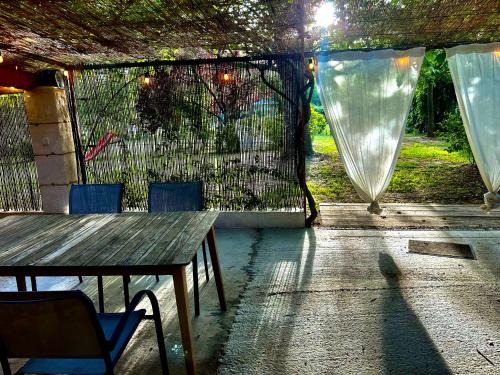 a patio with a table and chairs and a fence at Domaine Plan des Devens in Roussillon