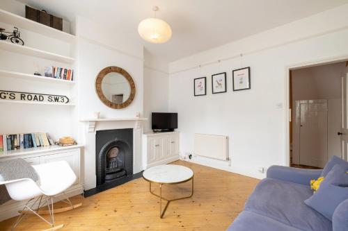 a living room with a blue couch and a fireplace at Charming Kings road in Bury Saint Edmunds