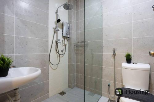 a bathroom with a shower and a toilet and a sink at Klebang Modern Classic Chill House Melaka By I Housing in Melaka