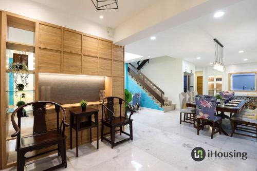 a dining room and living room with a table and chairs at Klebang Modern Classic Chill House Melaka By I Housing in Melaka