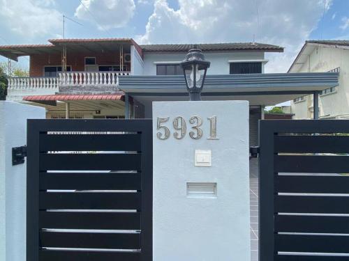 a house with a gate in front of a house at Klebang Modern Classic Chill House Melaka By I Housing in Melaka