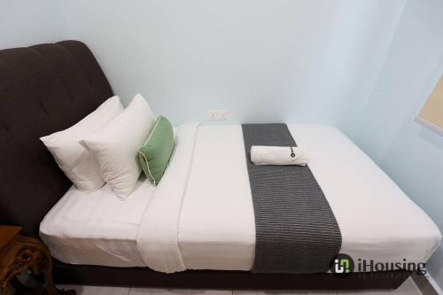 a bed with white sheets and pillows in a room at Klebang Modern Classic Chill House Melaka By I Housing in Melaka
