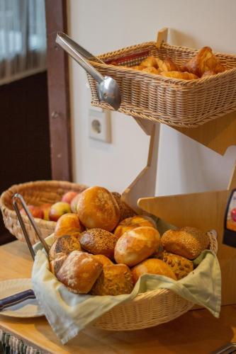two baskets of bread and apples on a table at Berggasthof Obere Firstalm in Schliersee