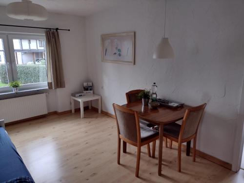 sala de estar con mesa de madera y sillas en Ferienwohnung mit Herz, en Nauort