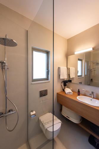 a bathroom with a shower and a toilet and a sink at Seascape Kalyves in Kalyves