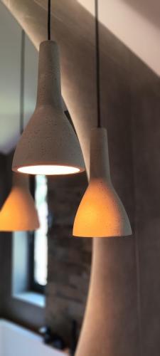 three lights are hanging from the ceiling at Cieślówka in Leżajsk