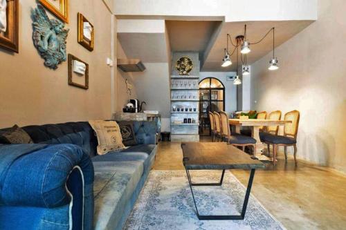 a living room with a couch and a table at Beautiful 3 Bedroom Baroque House near Asoke BTS in Bangkok