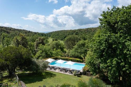 an aerial view of a resort with a pool and trees at Borgo dei Fondi in Siena