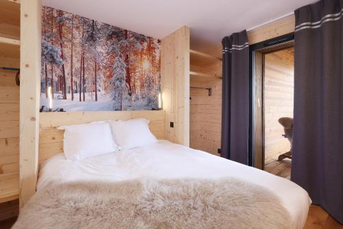 1 dormitorio con 1 cama con una pintura en la pared en Résidence l'Insolite, en Font-Romeu-Odeillo-Via