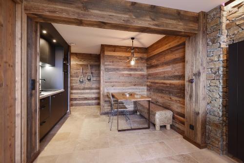 a kitchen with wooden walls and a table and chairs at Résidence l'Insolite in Font-Romeu