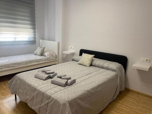 a bedroom with a bed with two pillows on it at BALERMAPLAYA calle lago in Balerma