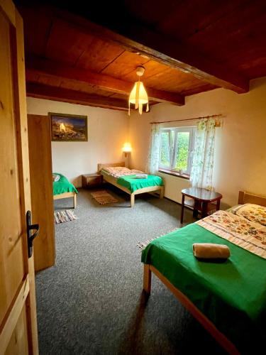 a hotel room with two beds and a window at u bażanta in Uherce Mineralne (7)