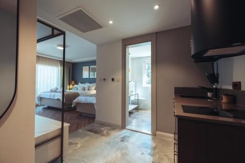 a room with a bedroom with a bed and a bathroom at Makarska City Bay Studios in Makarska