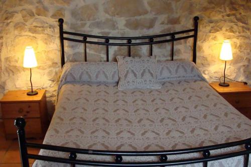 a bedroom with a bed with two lamps on tables at Gîtes du Mas Champion - Piscine, Soleil, Nature & Calme - groupes in Saint-Just-et-Vacquières
