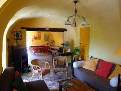 a living room with a couch and a table at Gîtes du Mas Champion - Piscine, Soleil, Nature & Calme - groupes in Saint-Just-et-Vacquières