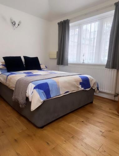 a bedroom with a large bed in front of a window at The Annex - Penzance town centre with parking in Penzance